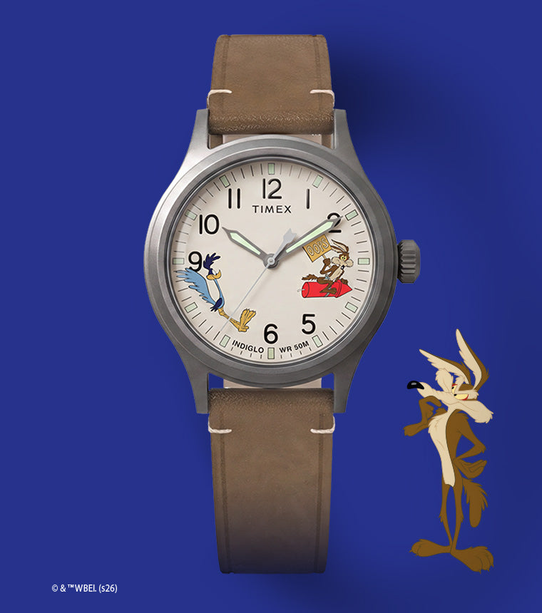 TW2Y99400 Reloj Timex Expedition® Scout de Looney Tunes con el Correcaminos y el Coyote, con una esfera de color crema con motivos de los personajes y una correa de piel marrón con ilustraciones del Coyote.