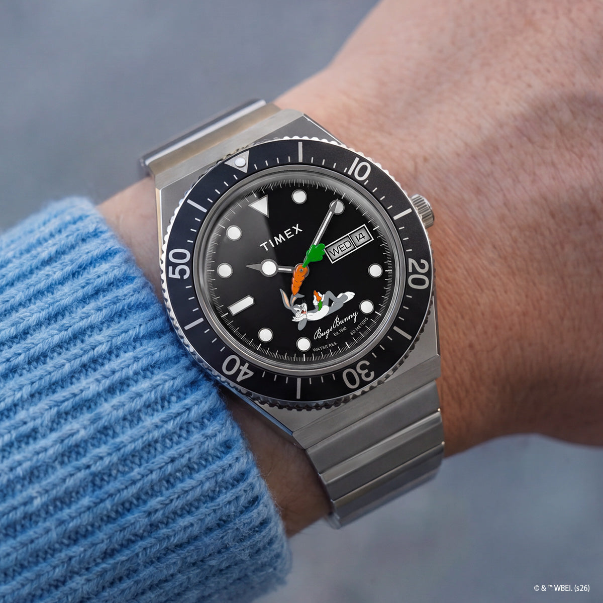 TW2Y99200 Bugs Bunny x Timex M79 Automatic Signature Edition watch worn on a wrist, featuring a black character dial and silver-tone bracelet.