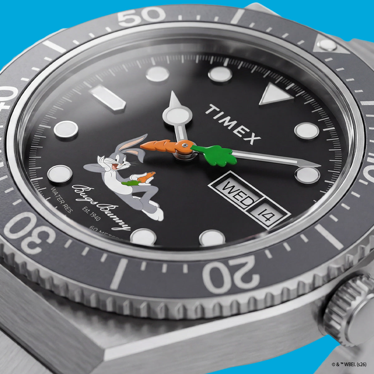 TW2Y99200 Detailed view of the black dial with reclining Bugs Bunny artwork, his signature, a carrot-shaped seconds hand, and a day-date display.