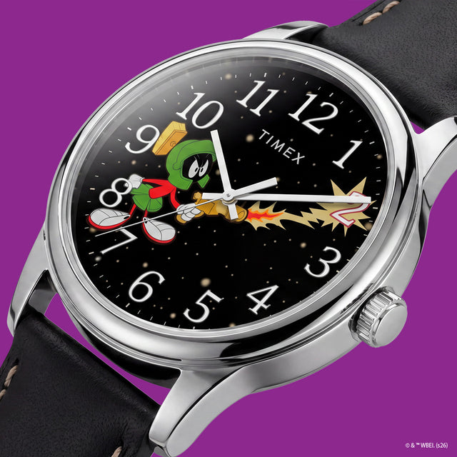 TW2Y99300 Close-up of the Marvin the Martian watch dial showing Marvin firing a ray gun toward a tilted numeral 2 against a starry background.