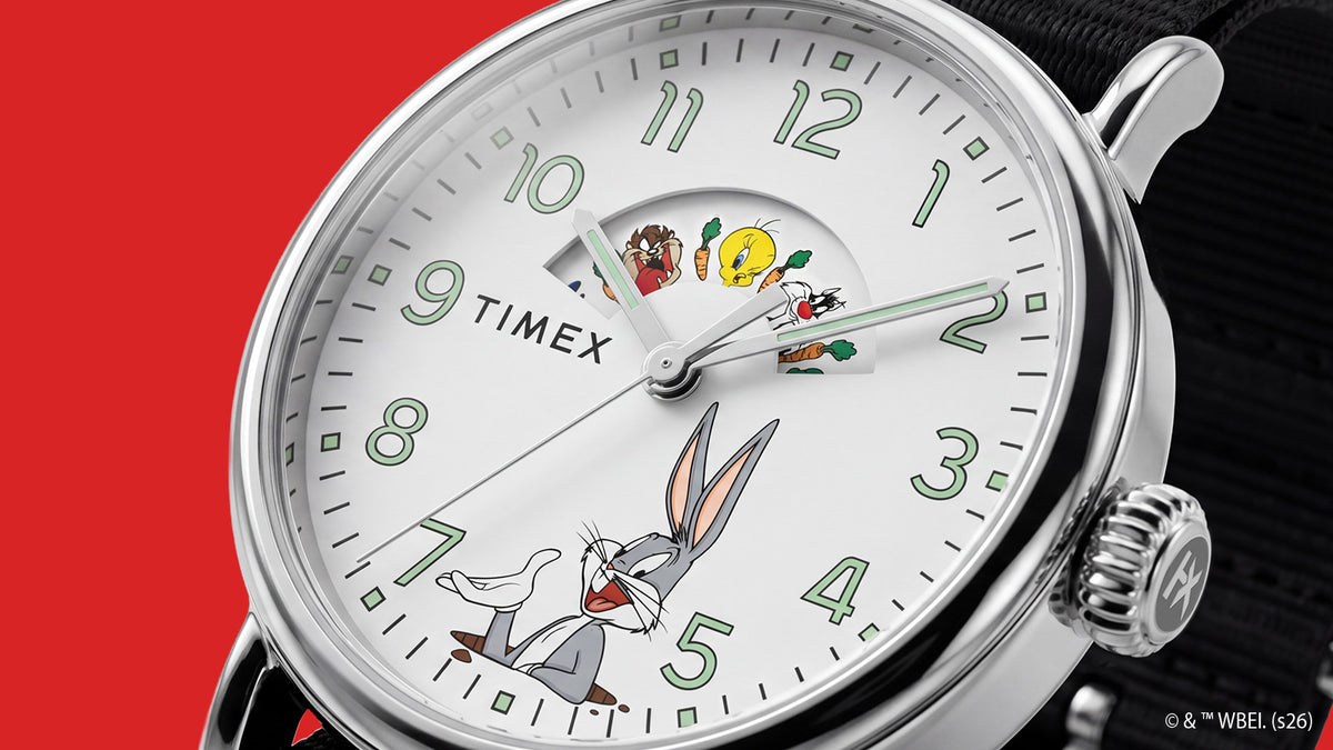 TW2Y99100 Close-up of the Looney Tunes Bugs and Friends x Timex Standard watch featuring Bugs Bunny, a character display, green numerals, and a silver-tone case.