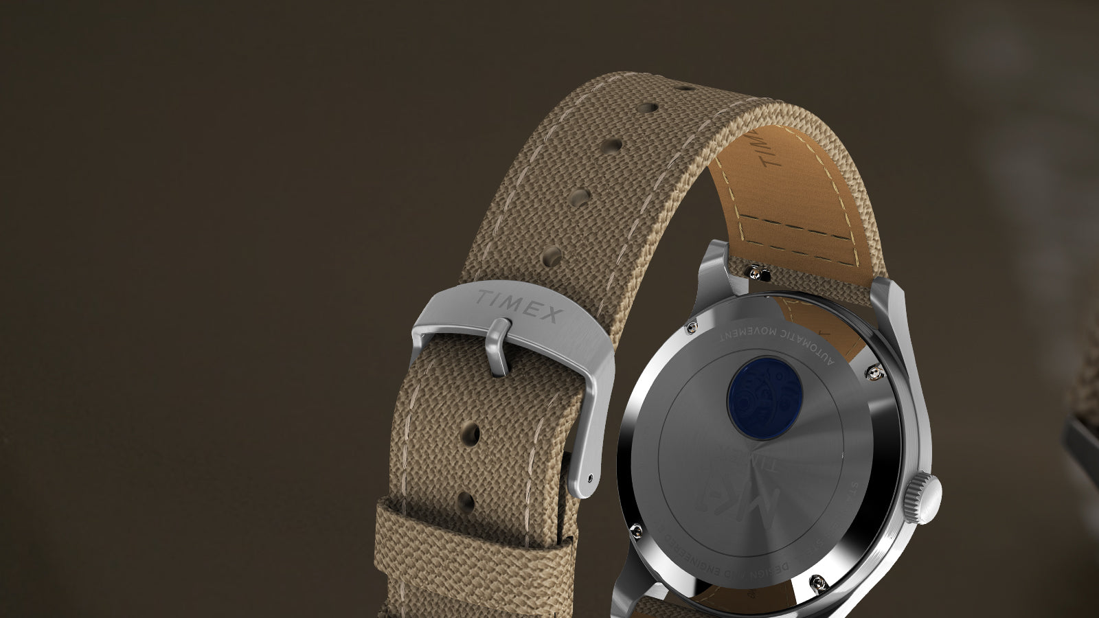 Rear view of the MK1® Automatic watch showing its case back, tan fabric strap, and Timex buckle.