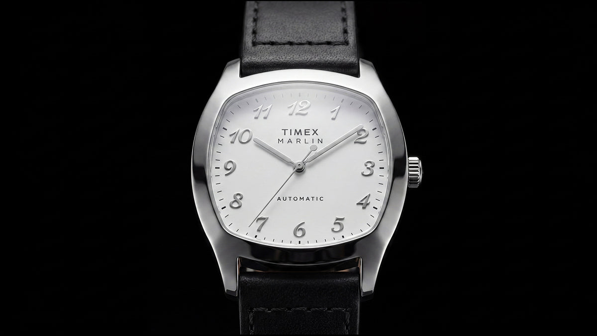TW2Y84300 Front close-up of the Marlin® Chatham Automatic watch with raised Arabic numerals and a black leather strap against a black background.