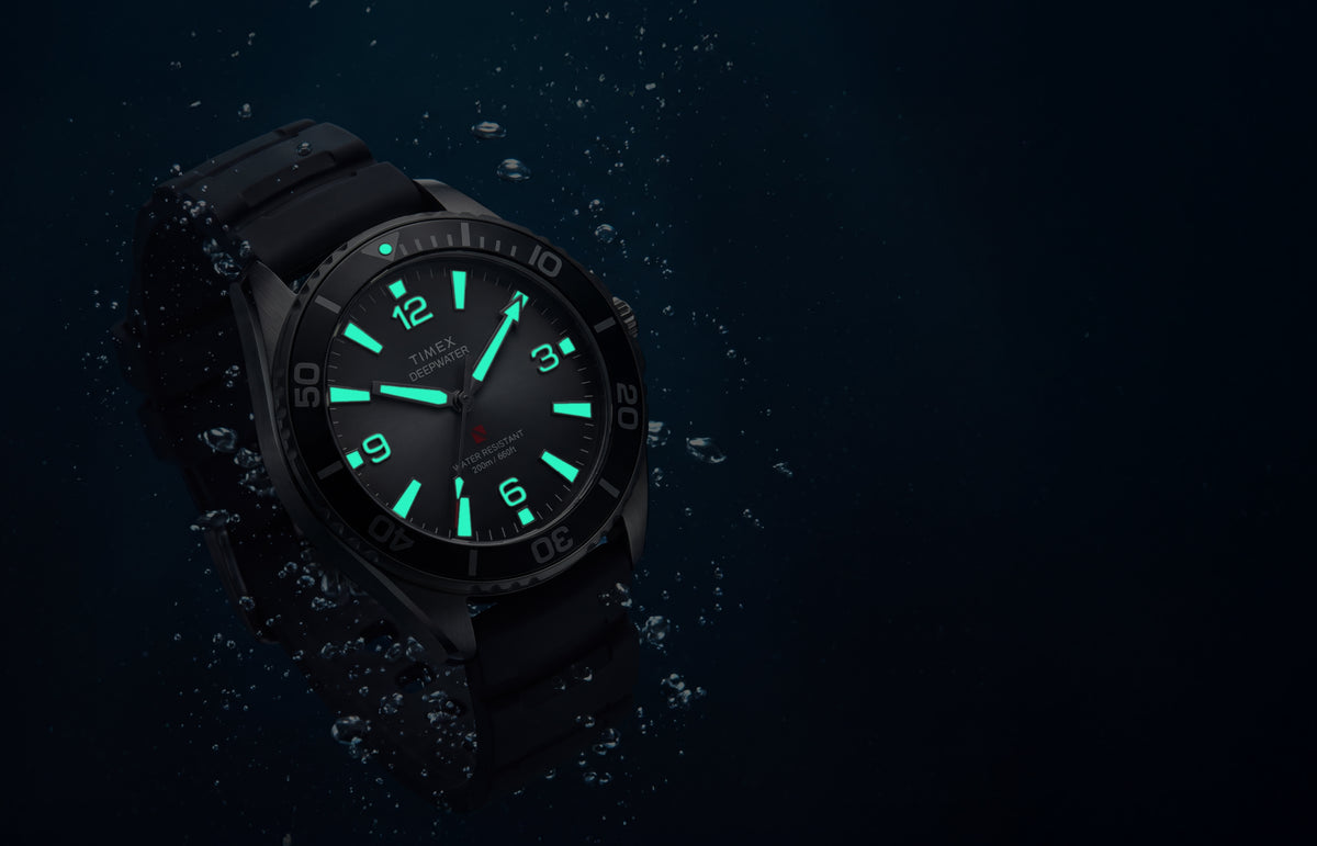 TW3A02000 Deepwater Arctic 200 watch underwater with luminous hands and hour markers glowing aqua.
