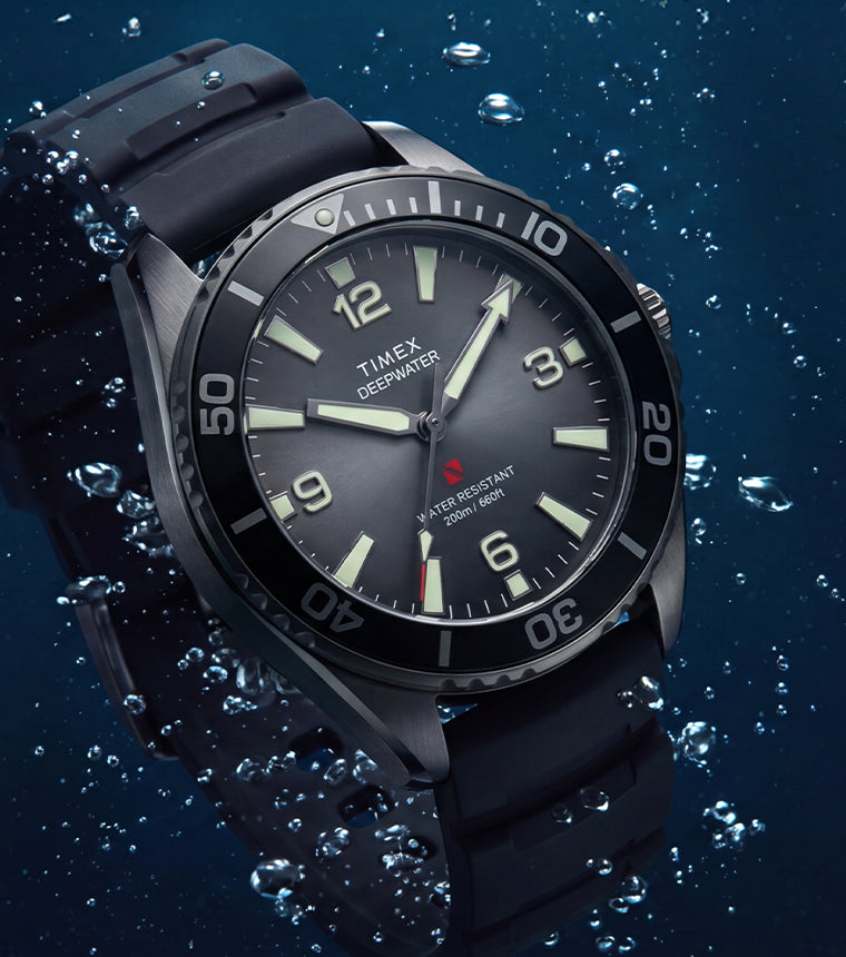 TW3A02000 Deepwater Arctic 200 watch with a gray dial and black strap surrounded by underwater bubbles.