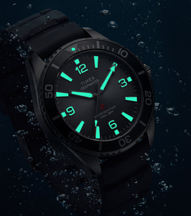 TW3A02000 Deepwater Arctic 200 watch underwater with luminous hands and hour markers glowing aqua.