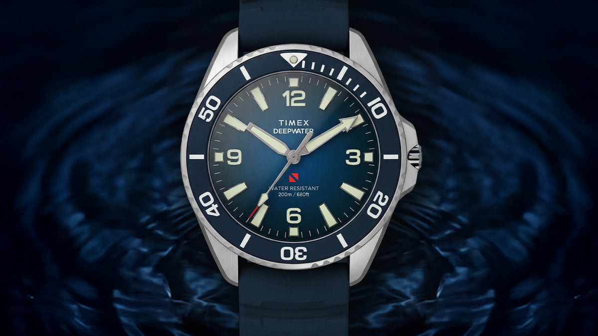 TW3A01900 Front view of the blue Deepwater Arctic 200 watch against a dark, rippling water background.