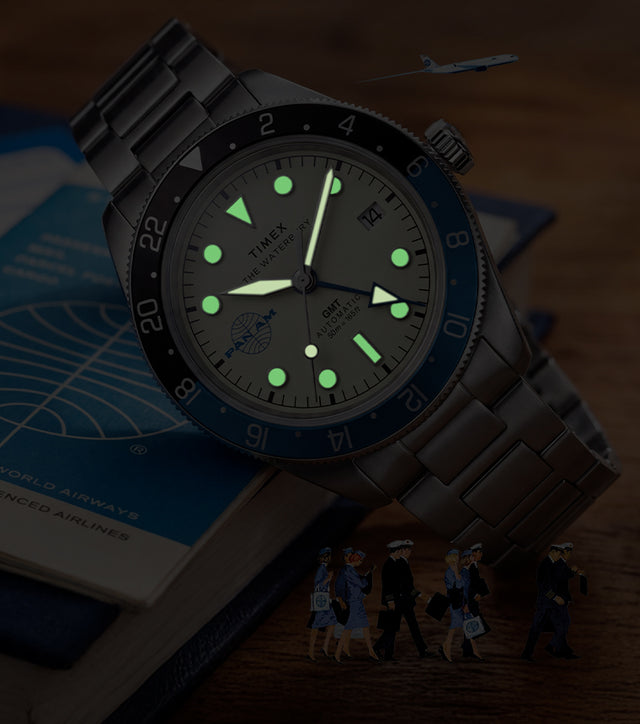 TW2Y94300 Pan Am x Timex Waterbury Automatic GMT watch with luminous hands and markers glowing in the dark.