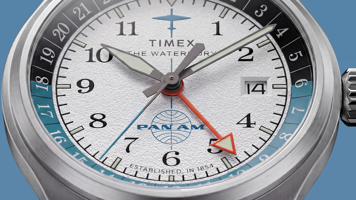 TW2Y94600 Close-up of the textured white dial, orange GMT hand, date window, and two-tone 24-hour scale.