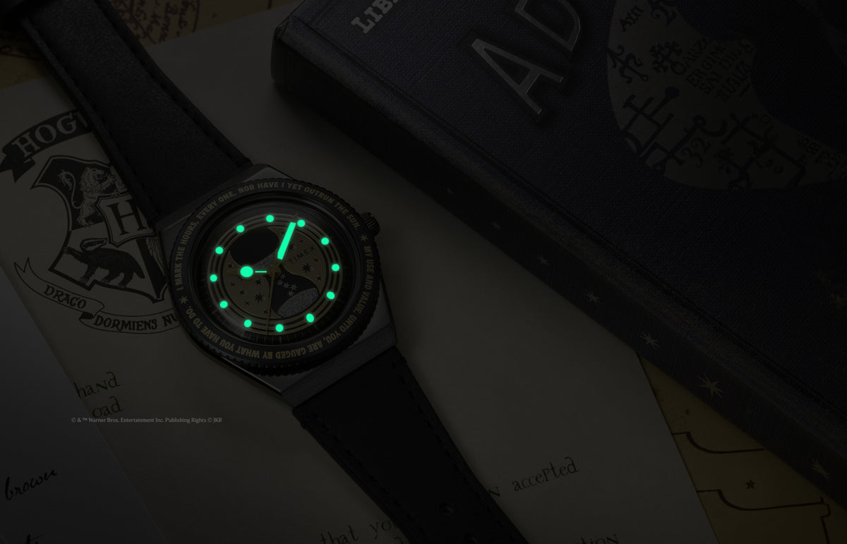 TW2Y76000 The watch in darkness, showing its glowing green hands and hour markers.