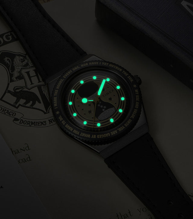 TW2Y76000 The watch in darkness, showing its glowing green hands and hour markers.
