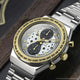 TW2Y75900 Angled close-up of the watch, showing its star-patterned dial, two dark subdials, gold-tone bezel, and metal bracelet.