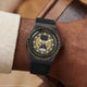 TW2Y76000 The black watch and strap worn on a wrist, showing the hourglass dial.
