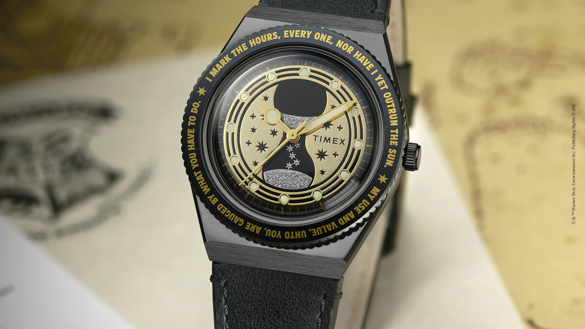 TW2Y76000 Front view of the black watch, highlighting its gold hourglass dial, star details, and black strap.