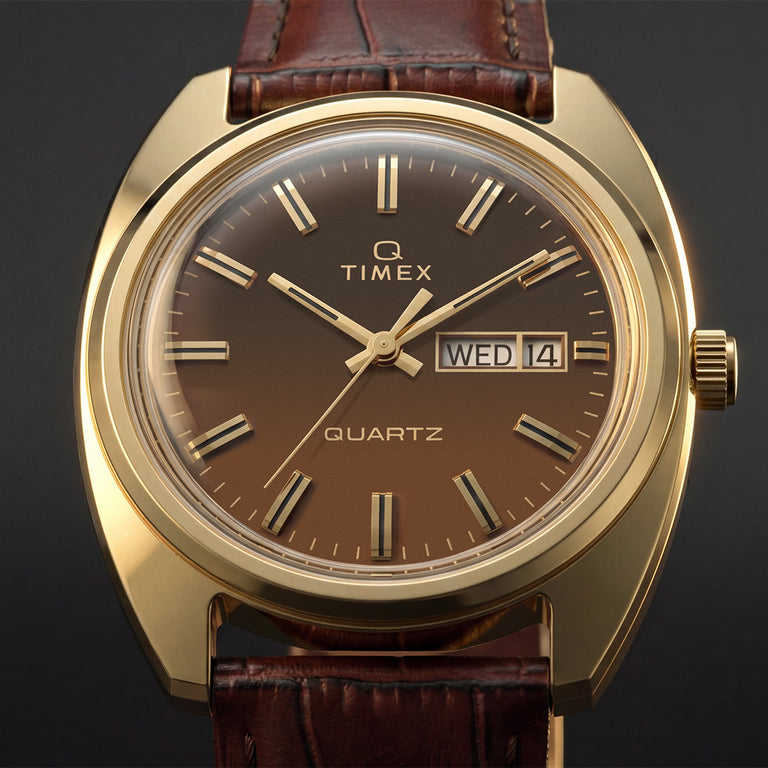 TW2Y87200 Close-up of the Timex 1978 Day Date Fumé Reissue’s brown gradient dial, gold-tone hands and hour markers, and day-date window.