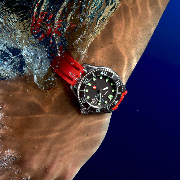 Red Tiburon Automatic with a red strap featured on a mans wrist in the water