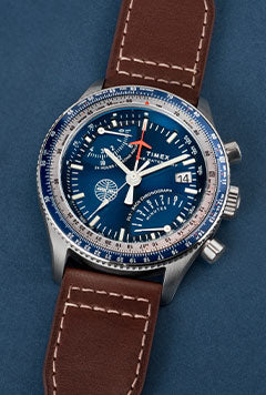 Timex x Pan Am Fly Back Chronograph watch lying against a blue background