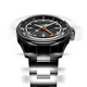 The Timex Atelier GMT Automatic photographed in motion, showcasing the dynamic design and reflective surfaces of the steel bracelet.