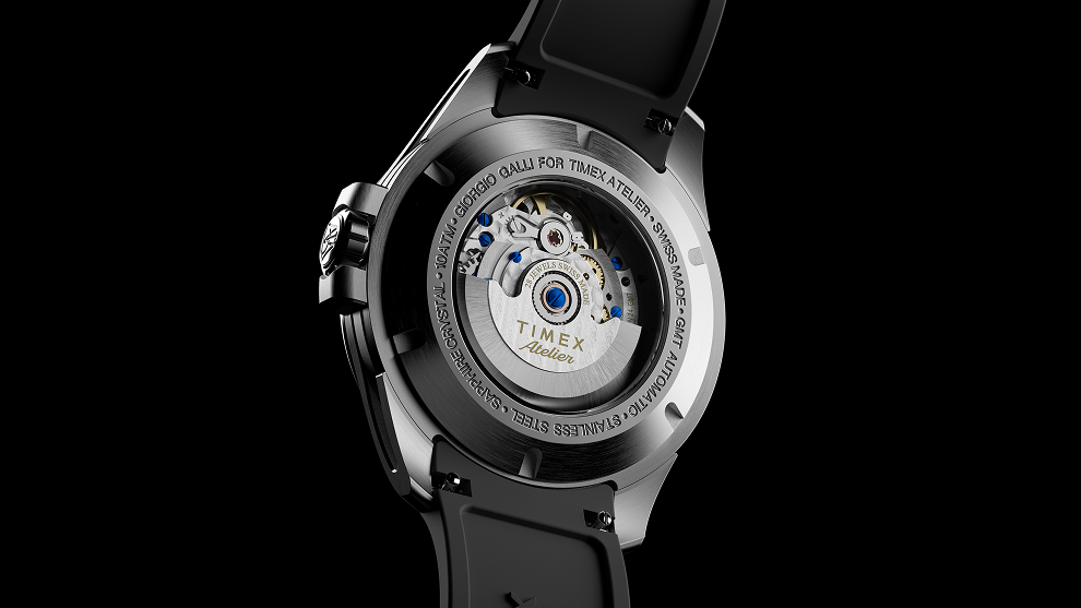 Exhibition caseback of the Timex Atelier GMT Automatic showing the Swiss automatic movement with visible rotor engraved “TIMEX Atelier.”