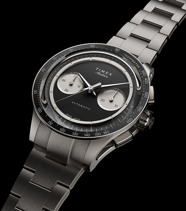 Timex Atelier Chronograph Automatic M1A Ti luxury watch featuring a brushed titanium bracelet, black dial, silver-tone chronograph subdials, tachymeter bezel, and Swiss-made automatic movement.
