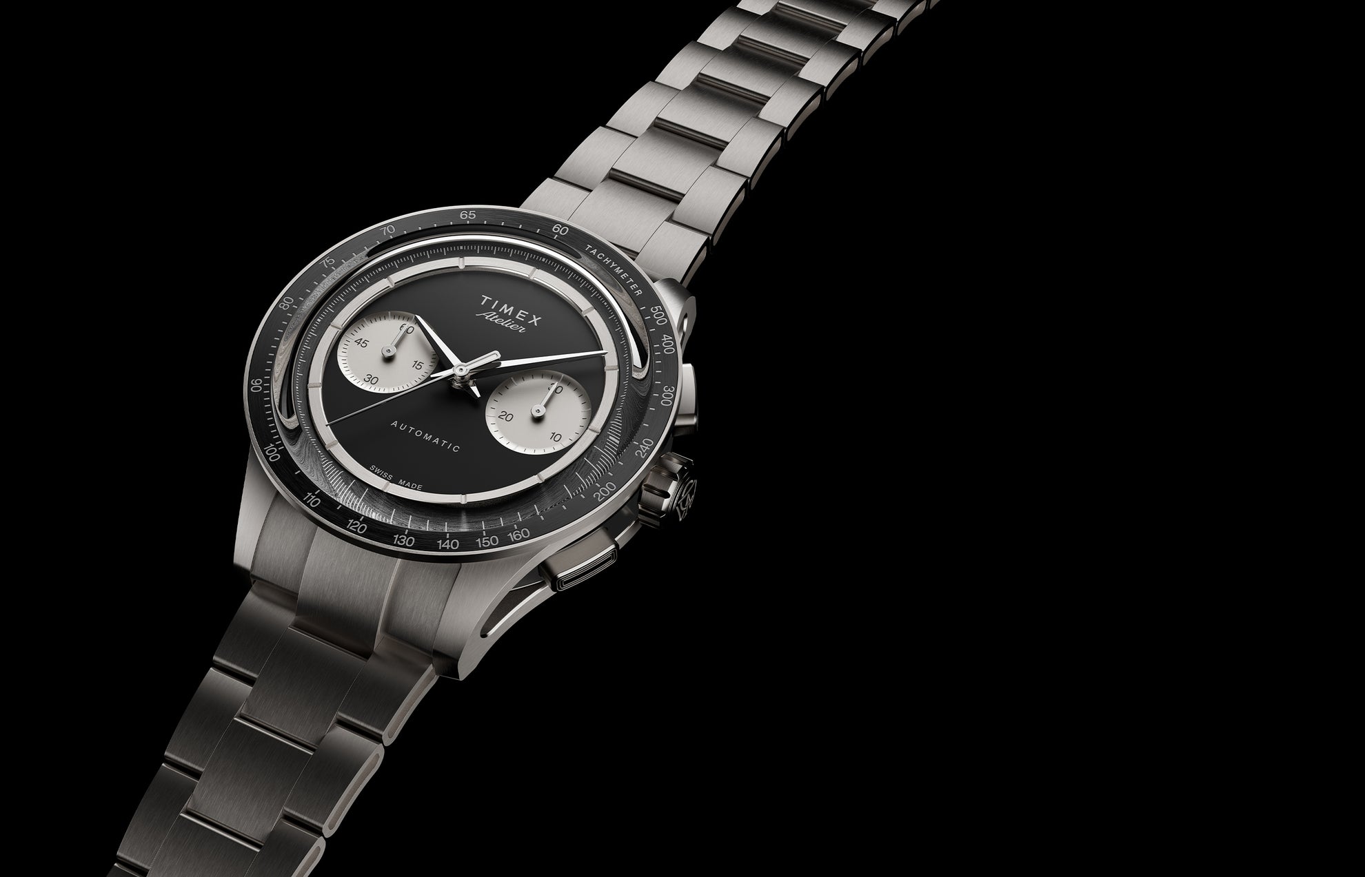 Timex Atelier Chronograph Automatic Ti M1a watch with black dial, titanium case, and integrated bracelet angled on black background