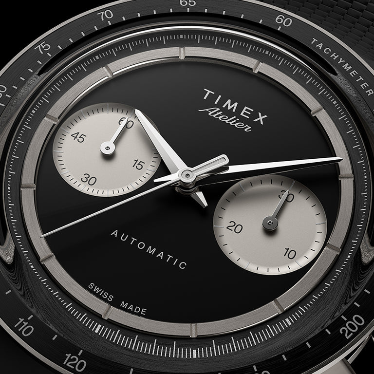 Close-up of the Timex Atelier Chronograph Automatic M1a Ti black dial featuring contrasting silver-tone sub-dials, applied markers, and polished chronograph hands.