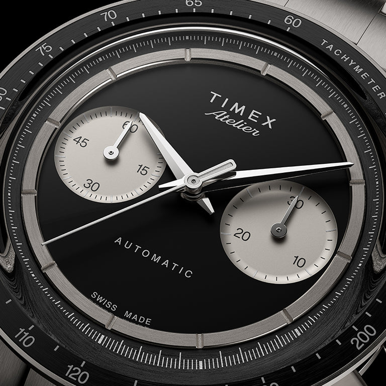 Close-up of Timex Atelier Chronograph Automatic Ti M1a black enamel dial with dual subdials and polished hands