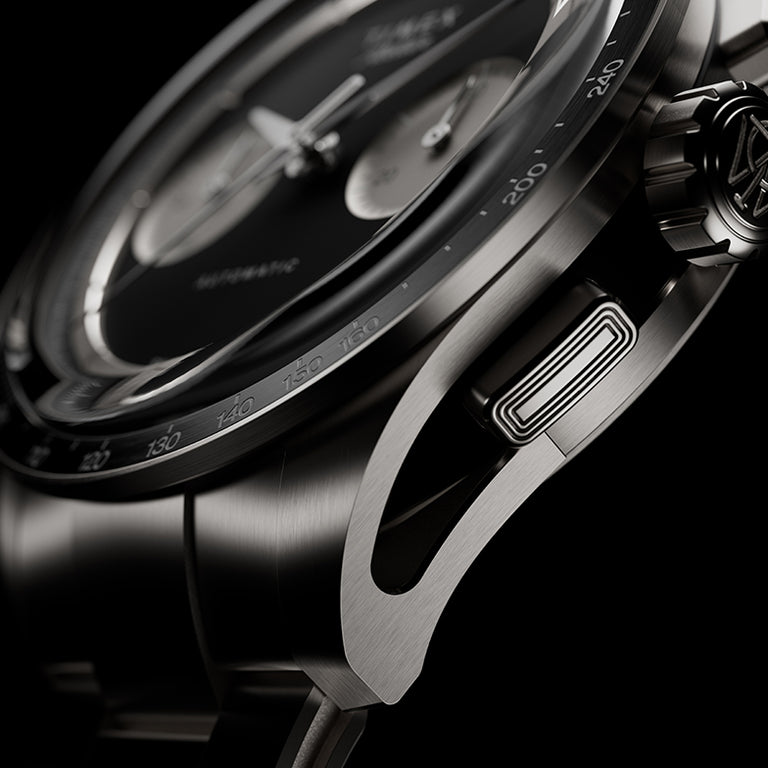 Side detail of Timex Atelier Chronograph Automatic Ti M1a titanium case showing tachymeter bezel, crown, and chronograph pusher