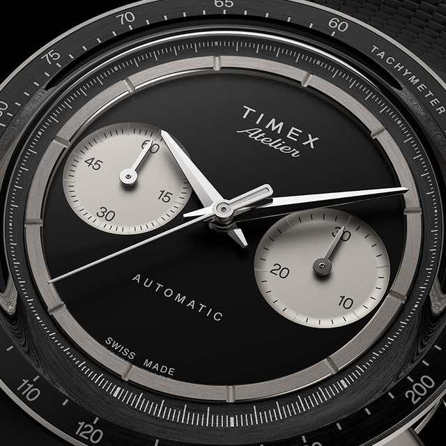 Close-up of Timex Atelier Chronograph Automatic Ti M1a black dial with dual subdials and tachymeter scale