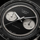 Close-up of Timex Atelier Chronograph Automatic Ti M1a black dial with dual subdials and tachymeter scale