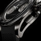 Macro view of Timex Atelier Chronograph Automatic Ti M1a titanium case, crown, and chronograph pusher with rubber strap