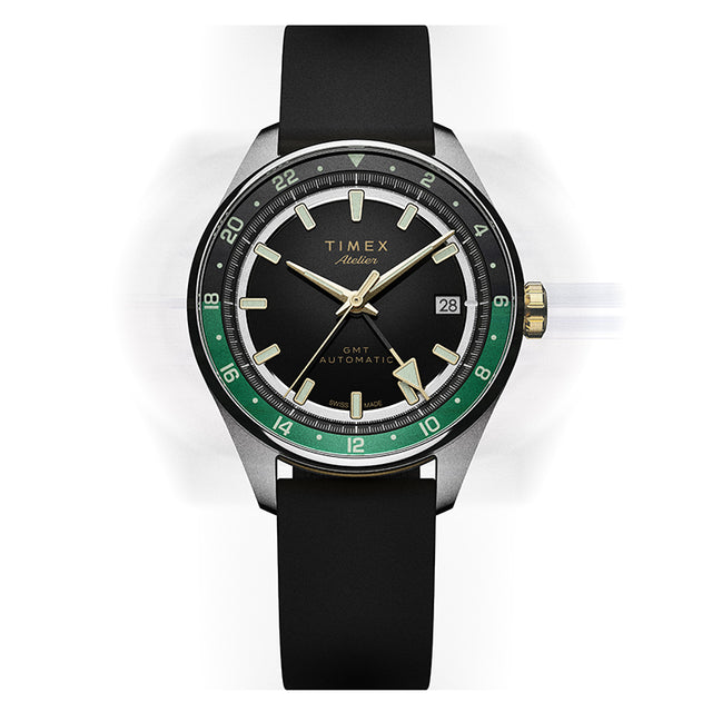 Front view of the Timex Atelier GMT Première M1a watch with a black dial, green GMT scale, and black rubber strap.