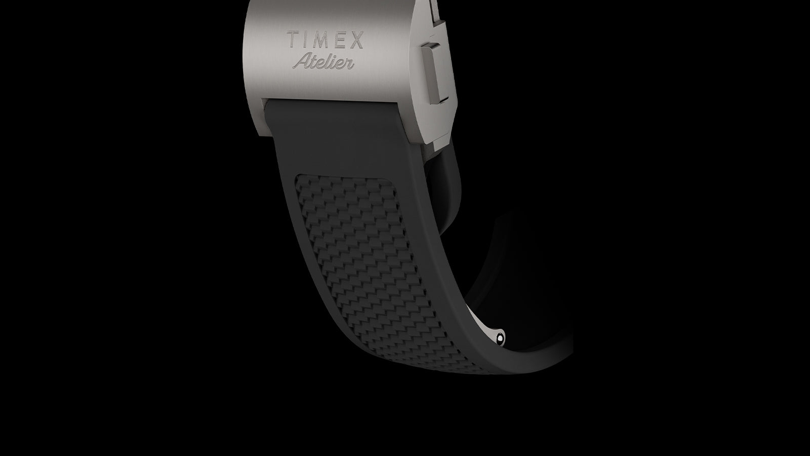 Timex Atelier engraved titanium clasp paired with a textured black integrated rubber strap on the Atelier Chronograph Automatic M1a Ti.