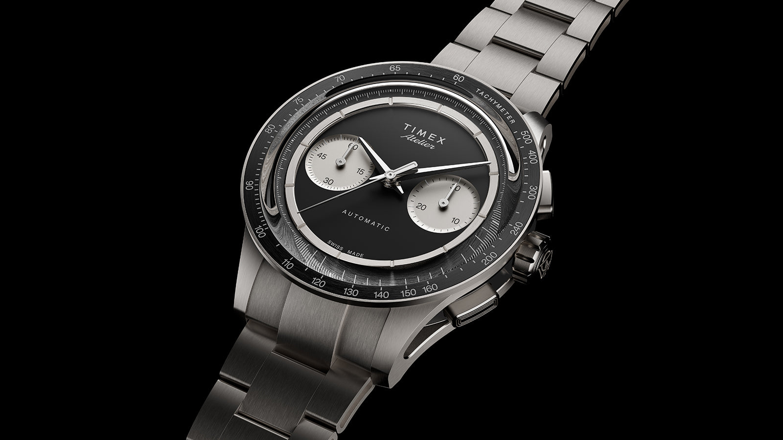 Timex Atelier Chronograph Automatic Ti M1a luxury titanium watch with black dial and metal bracelet on dark background