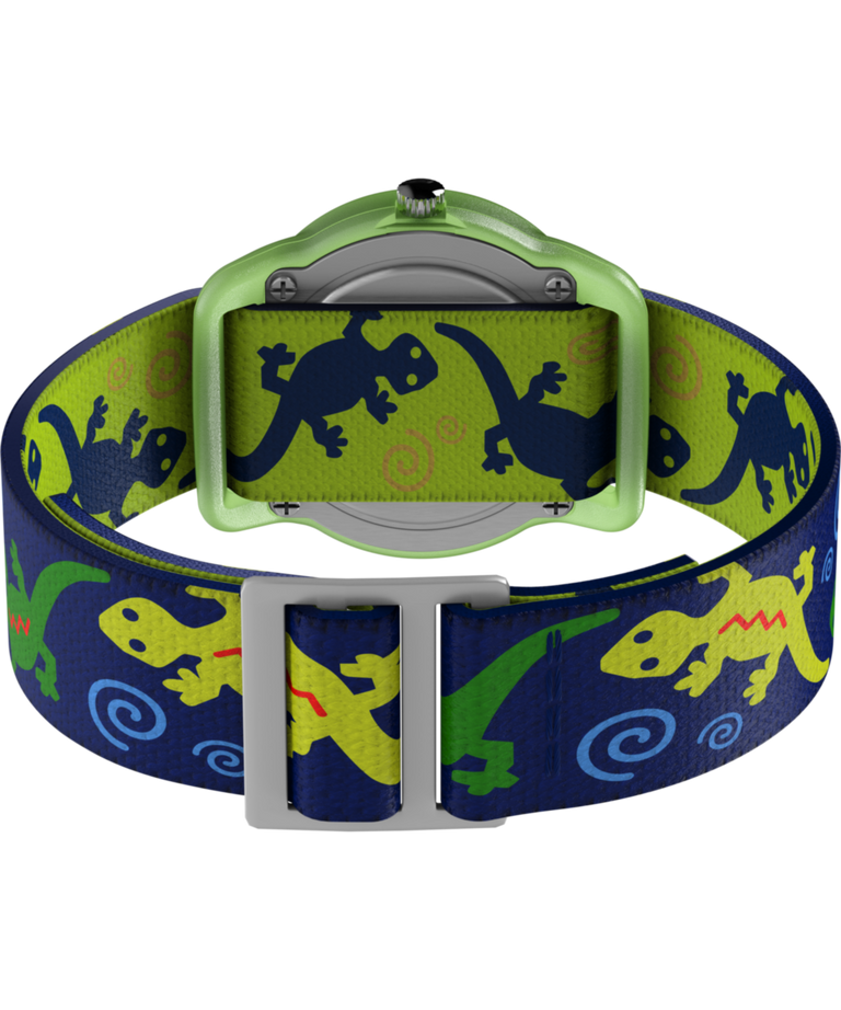 T72881 TIMEX TIME MACHINES® Reloj infantil de 29 mm con correa elástica de tela «Green Gecko». Imagen del fondo de la caja con accesorio.