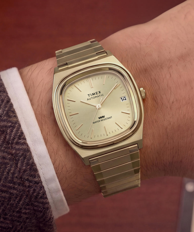 TW2Y07200 Timex® Automatic 1983 E Line Reissue 34mm Gold-Tone Expansion Band Watch Primary Wrist Image
