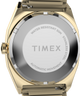TW2Y67700 Timex® Automático 1983, línea E, 34 mm, reloj con correa extensible de acero inoxidable. Imagen del fondo de la caja.
