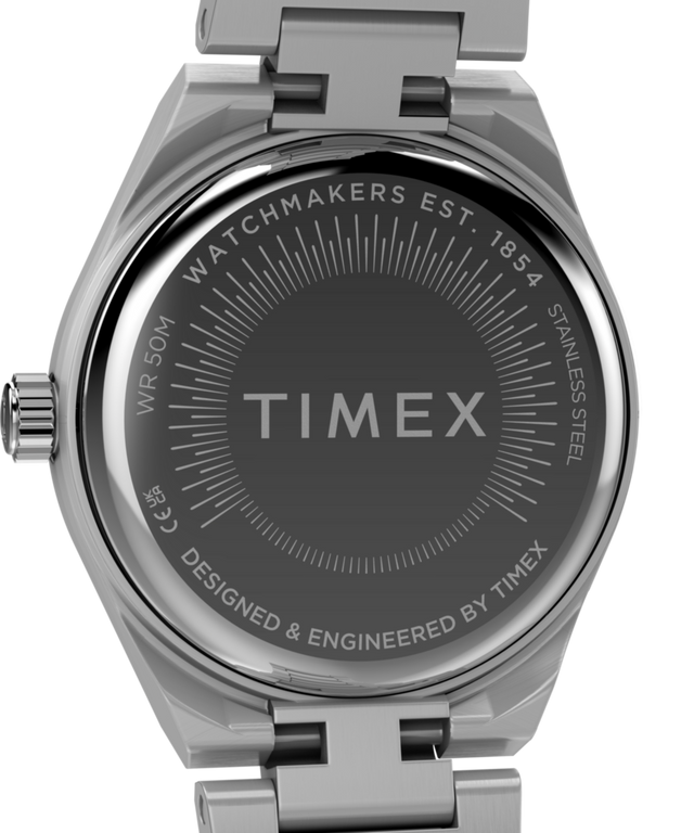 TW2Y68500 Q Timex® Continental Mini, reloj de 24 mm con brazalete de acero inoxidable. Imagen del fondo de la caja.