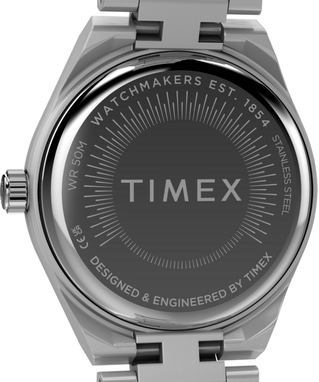 TW2Y77400 Q Timex® Continental Mini, reloj de 24 mm con brazalete de acero inoxidable. Imagen del fondo de la caja.