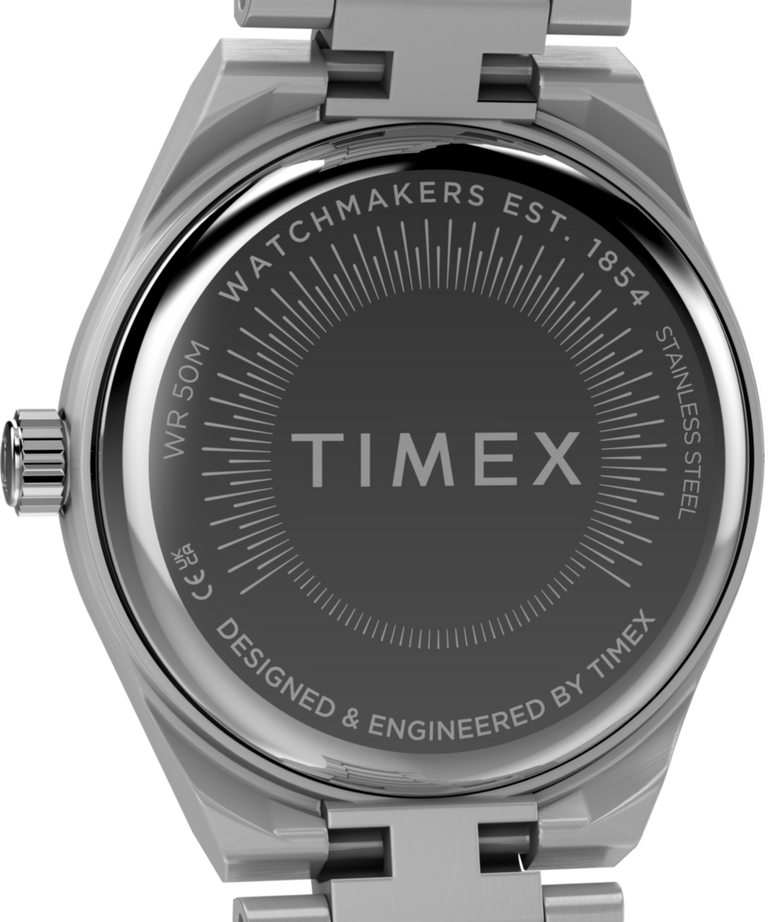 TW2Y77400 Q Timex® Continental Mini, reloj de 24 mm con brazalete de acero inoxidable. Imagen del fondo de la caja.