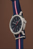 Weekender America 250 watch video highlighting the blue dial, red seconds hand, patriotic striped fabric strap, and America 250 commemorative design inspired by American heritage.