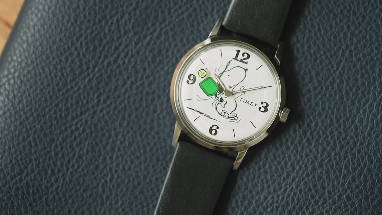 Product video of Peanuts® x Timex Marlin® Pickleball watch showcasing Snoopy pickleball dial animation, polished case details, INDIGLO® night-light feature, and engraved Peanuts caseback.
