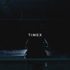 An 18-second video showcasing the Timex TW2W81500 Deepwater Meridian watch. The scene features the stainless steel timepiece glistening under soft studio lighting, rotating slowly against a dark, moody background. Close-up shots highlight the watch’s detailed blue dial, luminous hands, and bezel. The watch’s polished metal bracelet and water-inspired design elements evoke a rugged, nautical aesthetic. The video ends with a dramatic focus on the watch face as it fades to black.