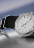 Timex Marlin Jet Automatic watch rotating on display, showcasing its silver-tone dial, domed crystal, navy woven strap, and polished stainless-steel case.