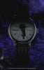 Video for the Timex x Wednesday Weekender watch collection. The video features moody, gothic visuals inspired by the Netflix "Wednesday" series. It showcases close-up shots of the watch with a striped leather strap and a dial featuring Wednesday Addams' silhouette holding an umbrella. Transitions highlight the Indiglo backlight effect, which reveals hidden gothic gate artwork on the dial.