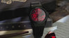 TW2Y99700 Harry Potter x Q Timex Sorcerer’s Stone watch video showcasing the red dial, black case and bracelet, luminous details, and themed caseback.