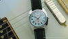 Fender x Timex watch shown in rotating product views alongside Fender electric guitars and accessories.