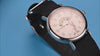 TW2Y99100 Rotating views of the Looney Tunes Bugs and Friends x Timex Standard watch, highlighting its character display, silver-tone case, and black strap against blue and red backgrounds.
