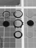 Video of Timex Atelier watch components arranged on a technical blueprint background, including case, bezel, dial, movement, and crystal.
