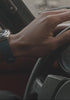A sleek product video featuring the Q Timex Chronograph with a blue dial and white sub-dials. The footage highlights the stainless steel case and bracelet, tachymeter bezel, and chronograph functions through dynamic close-ups and smooth lighting transitions, emphasizing its vintage-inspired yet modern design.